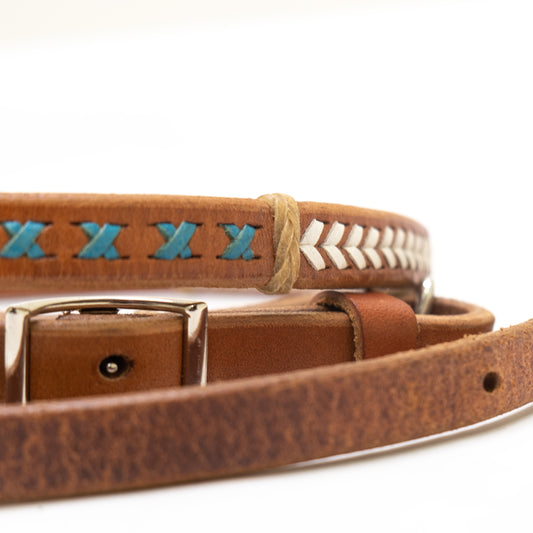 5/8" Sherrylyn Johnson barrel rein harness leather red, blue, and white lacing with rawhide braided dividers, and snaps.